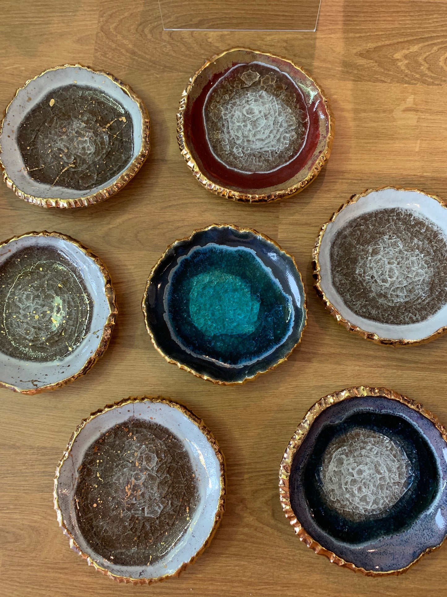 7 geode ring dishes in blue, white, grey, navy and red with gold detail. handmade ceramic, made in USA