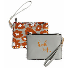 Load image into Gallery viewer, Small handheld purse, double sided. First side grey with orange letting HOOK EM and backside orange, black and white sparkles in cow print 
