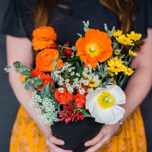 Load image into Gallery viewer, Person holding bouquet of colorful flower bouquet with red, orange, yellow, and white.
